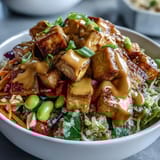 Golden brown tofu cubes and vibrant veggies over fluffy quinoa in a Peanut Tofu Power Bowl.