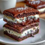 Decadent brownie cookies filled with rich cream cheese, baked to perfection for a sweet treat.  