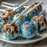 Vibrant school-colored cake pops with sparkling gold sprinkles, ready to delight guests at graduation parties.