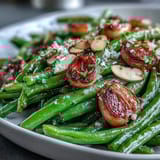 Crispy green beans tossed with caramelized garlic and roasted until tender, perfect for spring meals.  