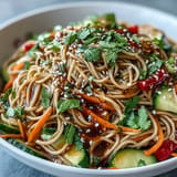 Chilled buckwheat noodles tossed with fresh veggies in tangy sesame ginger dressing.