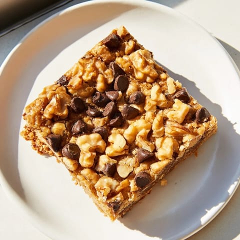 A close-up shot of homemade blondies: rich, buttery bars dusted with sugar, ready to eat.
