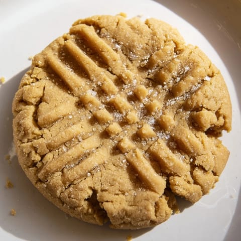 Warm, freshly baked peanut butter cookies, their sweet aroma filling the kitchen and ready to eat.