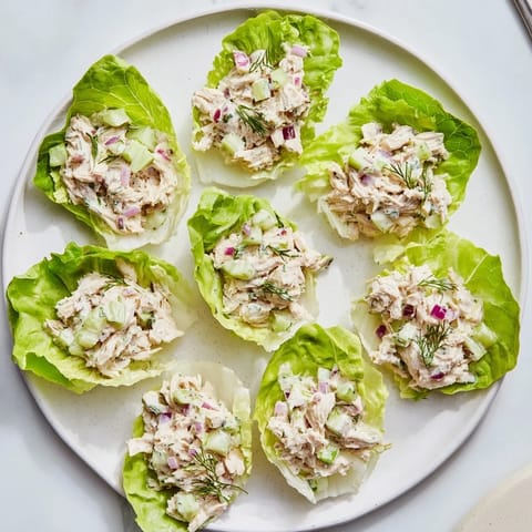 Tangy dill pickle chicken salad with celery and red onion served in fresh lettuce cups.