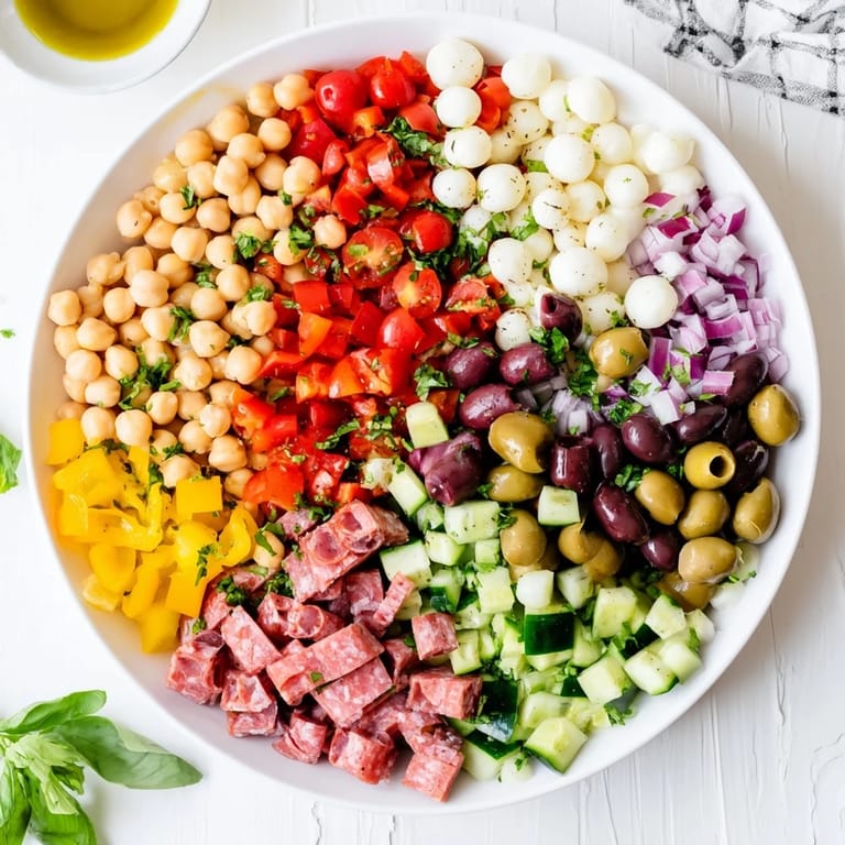 Vibrant Crunchy Antipasto Chopped Salad served in a white bowl, ready to eat as a gluten-free appetizer or light lunch.