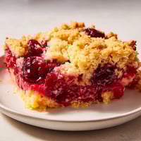 Golden brown dump cake, bubbling around the edges, perfect for a cozy dessert after dinner.