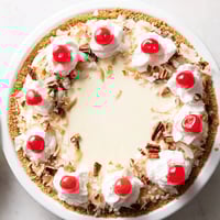 Creamy Millionaire Pie with chopped pecans, cherries, and coconut, a chilled summer dessert.